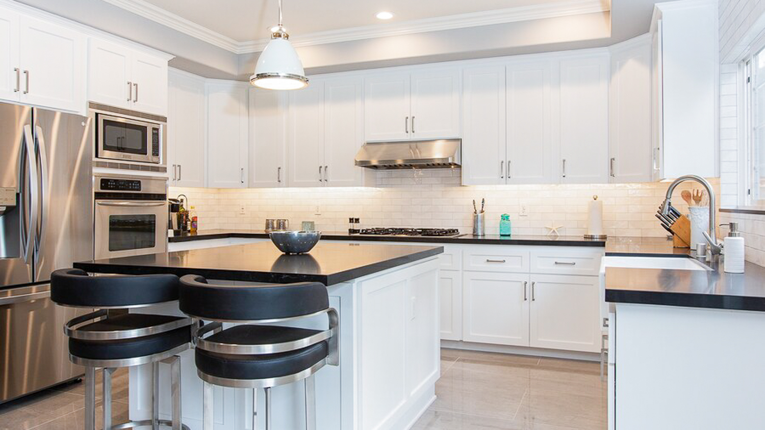 White kitchen with black island