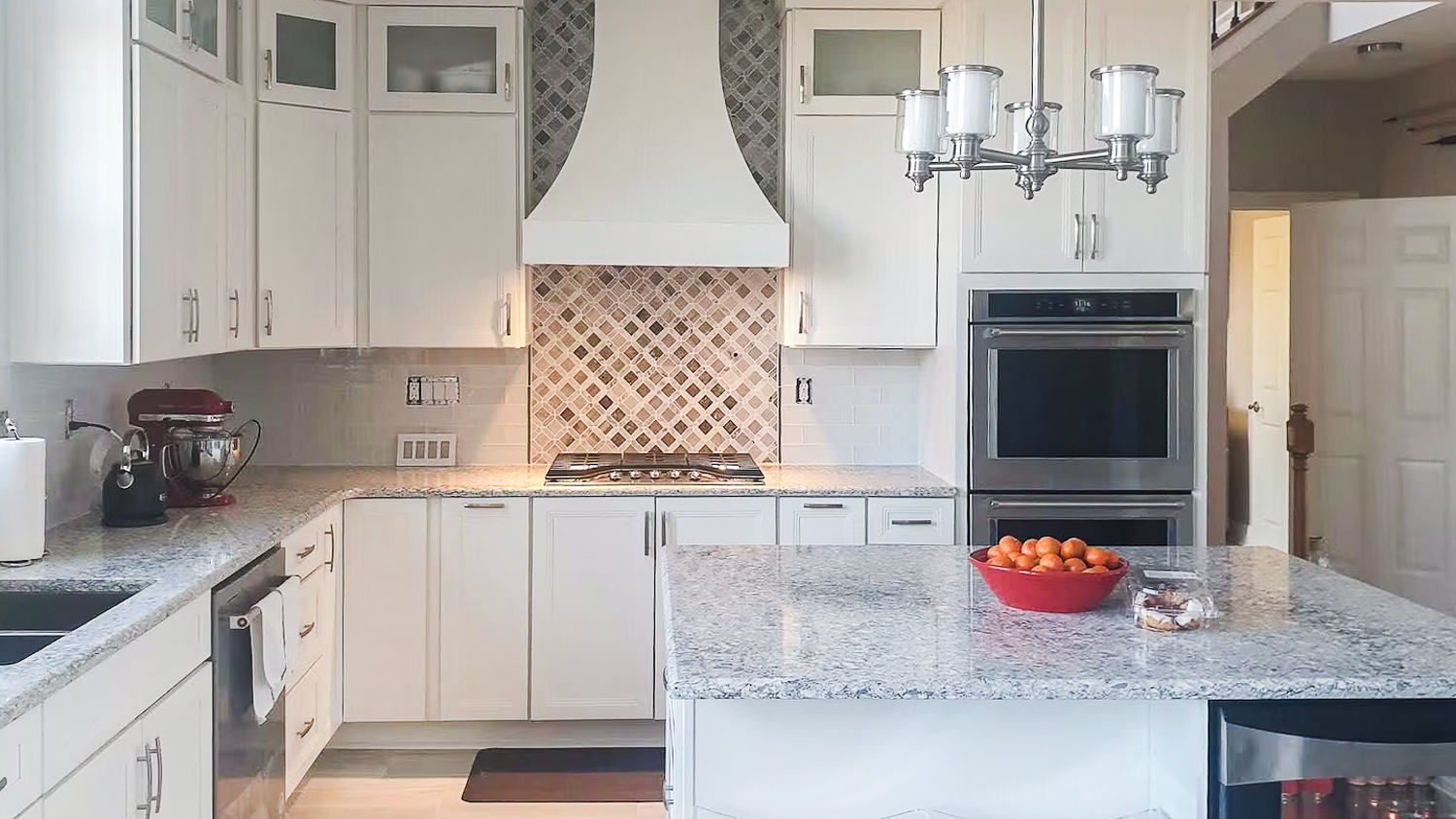 White kitchen with marble island