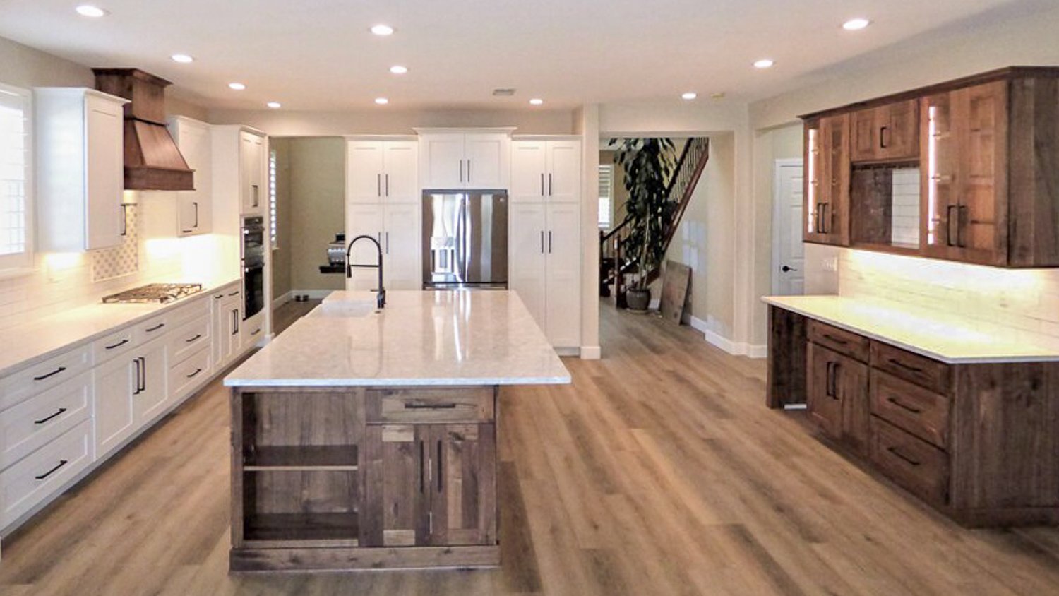 White kitchen with wooden floor 