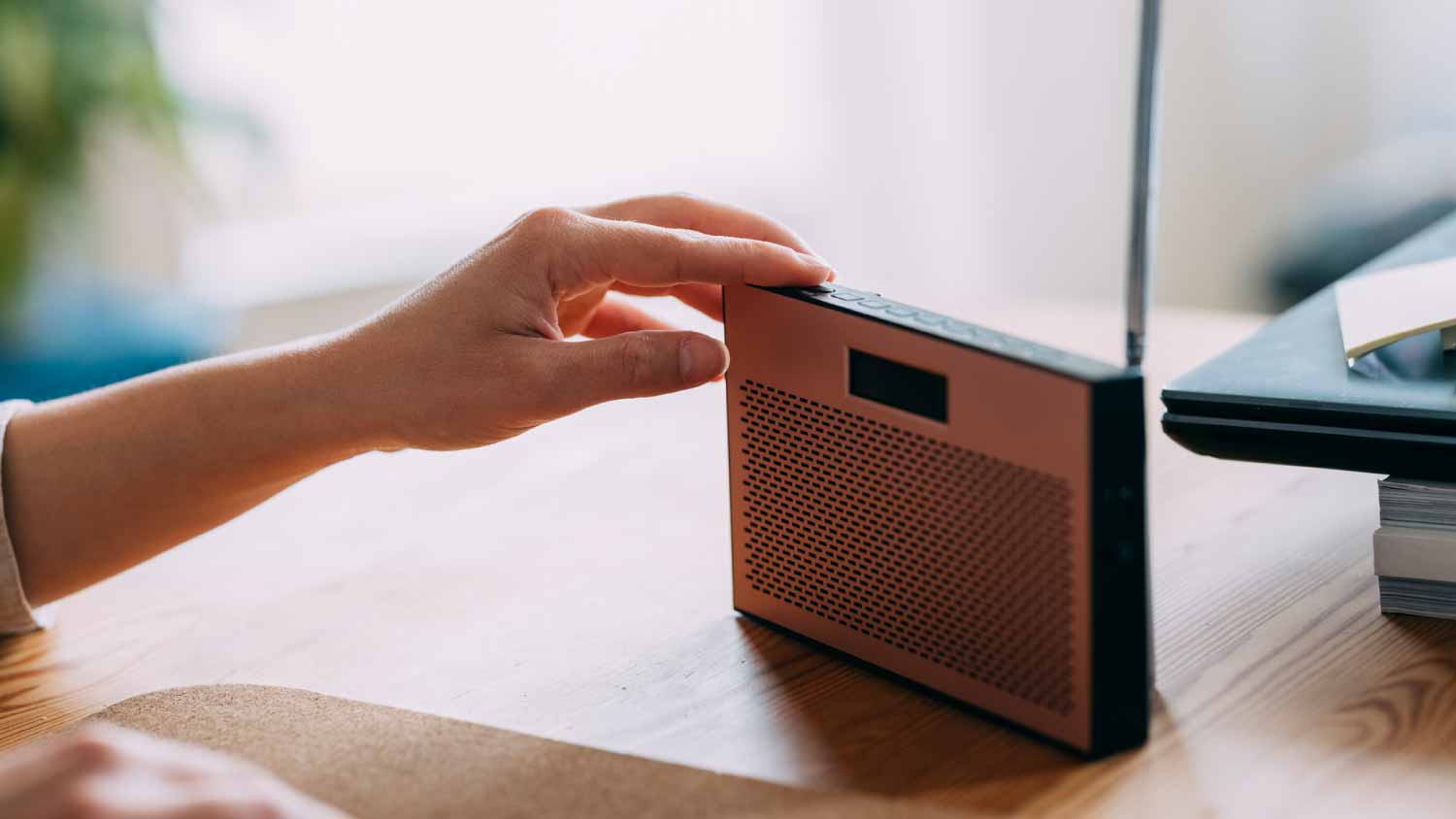 Woman adjusting the sound volume on the radio