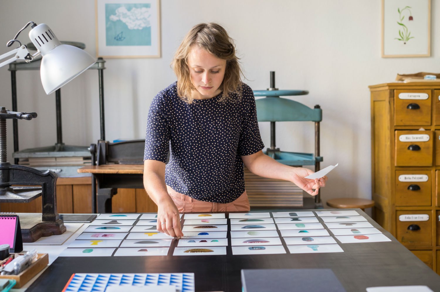 Woman checking photos of ceramics