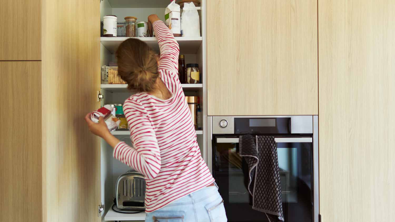 Woman cleaning cabinets