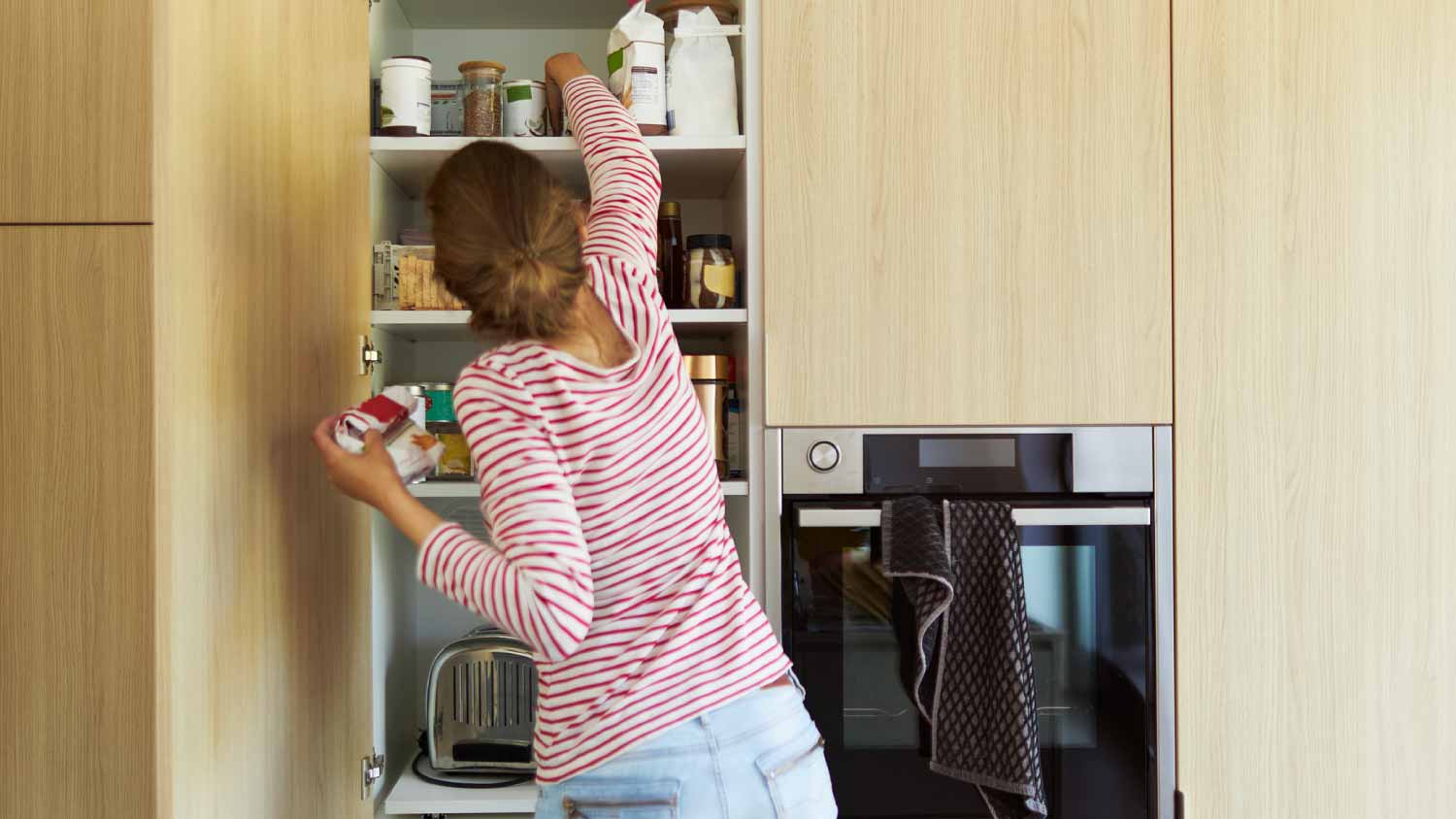 Woman cleaning cabinets 