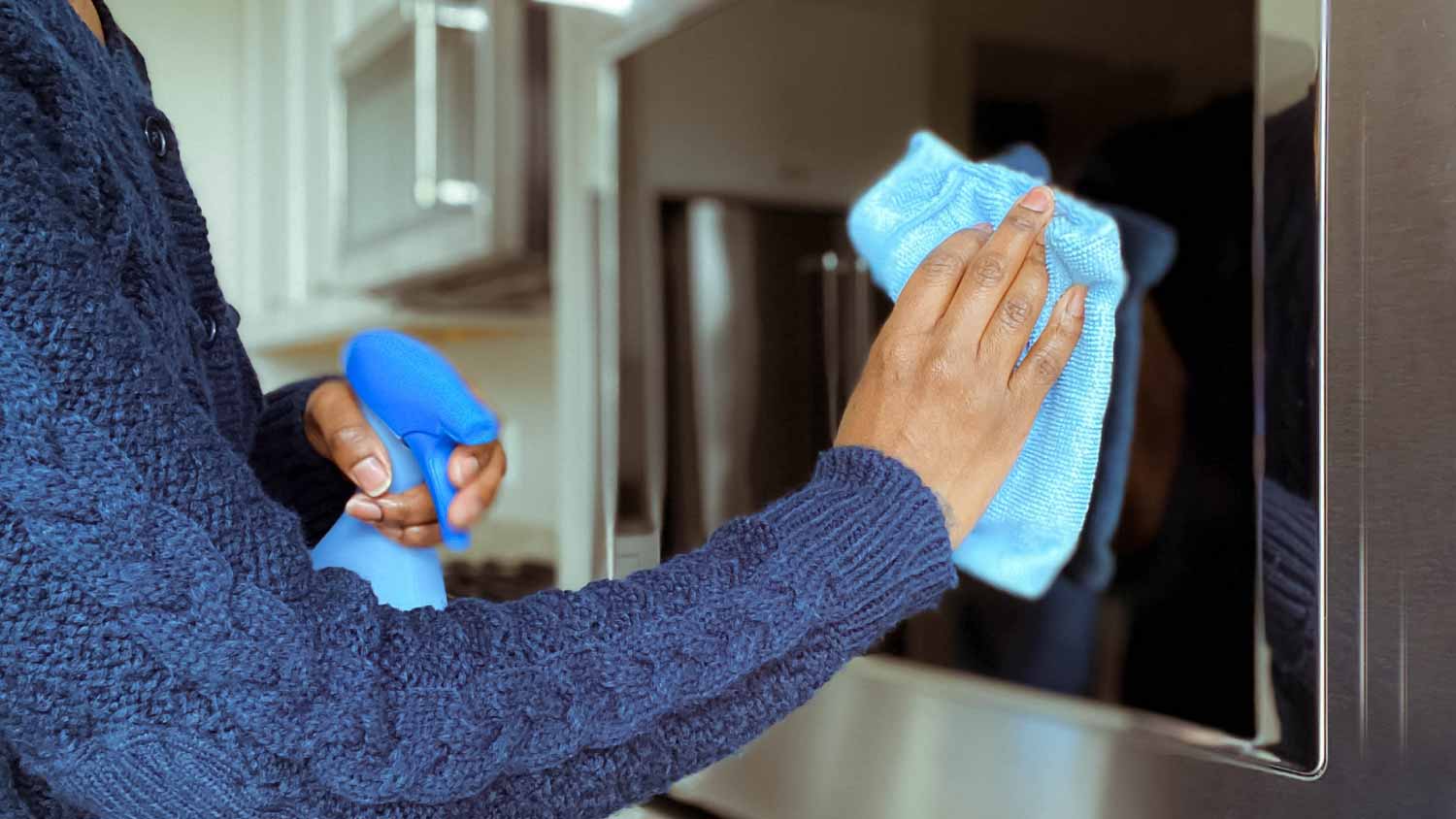 Woman cleaning microwave