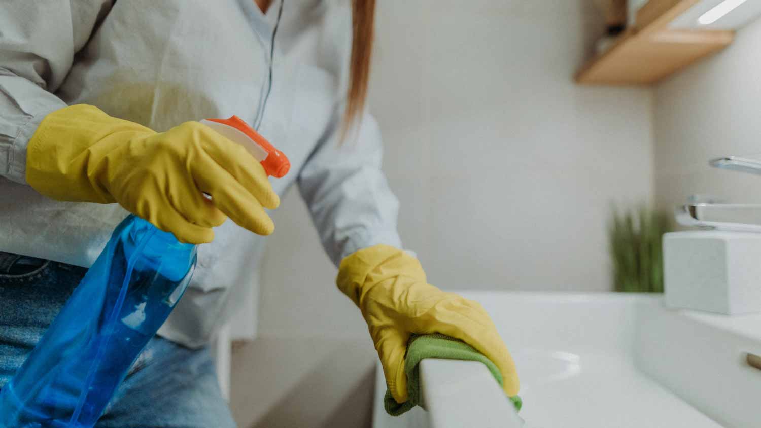 Woman cleaning sink 