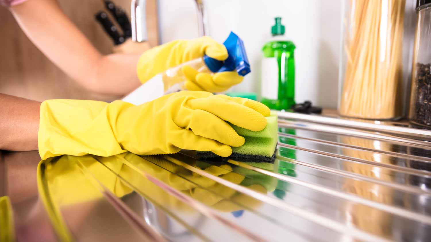 Woman cleaning steel sink