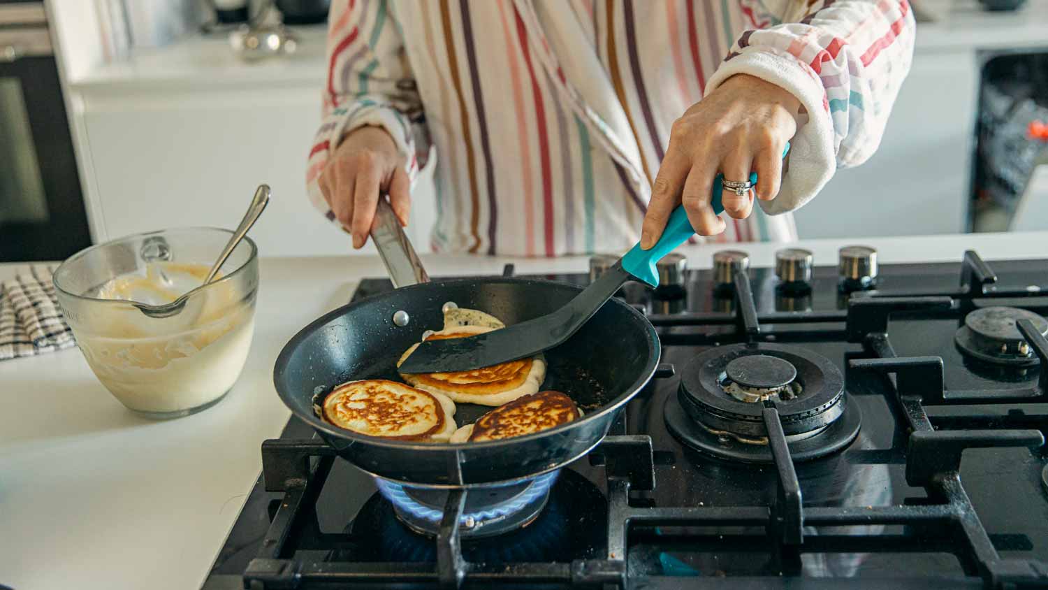 Woman cooking homemade pancakes 