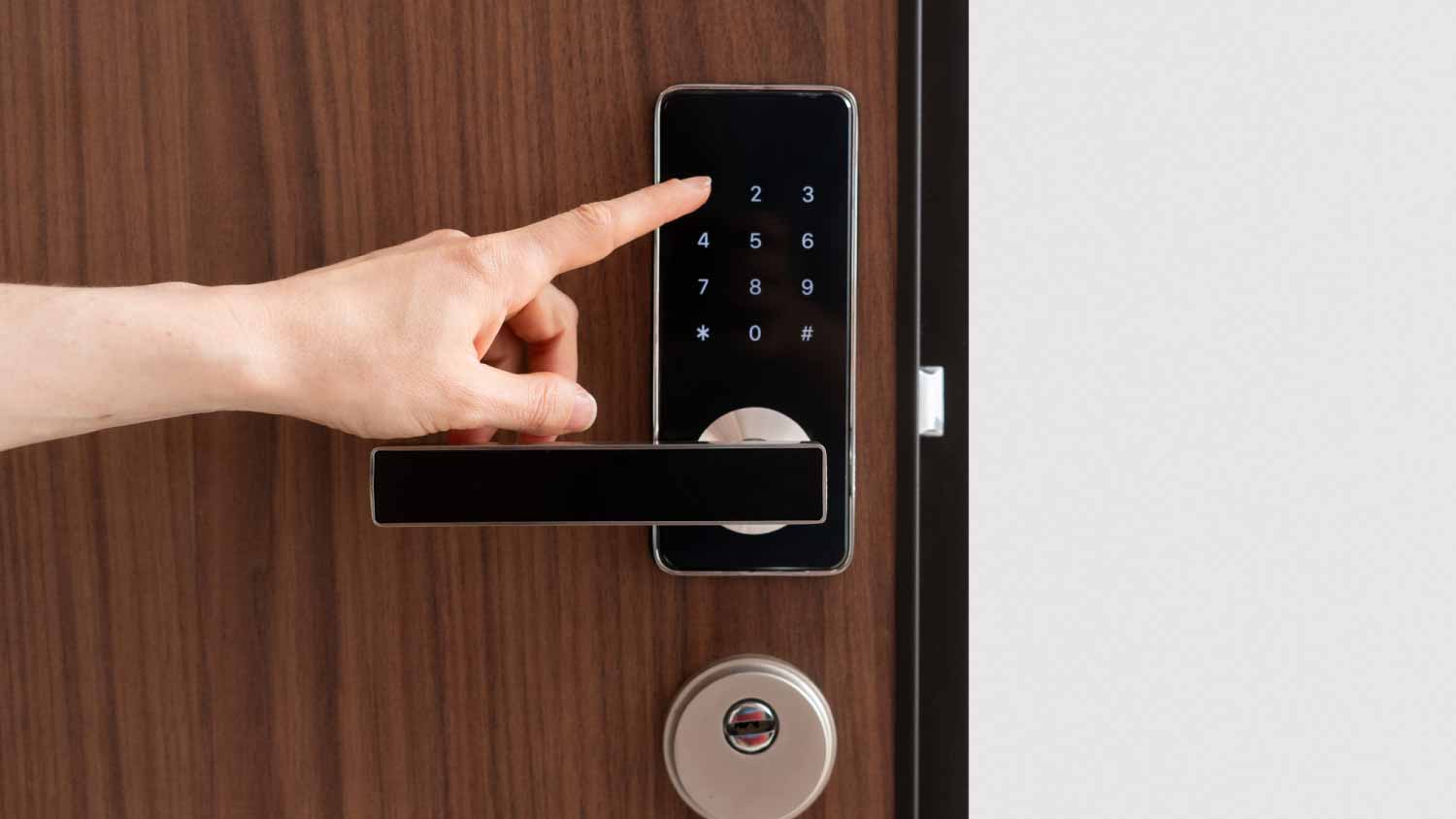 Woman entering password code on digital door lock