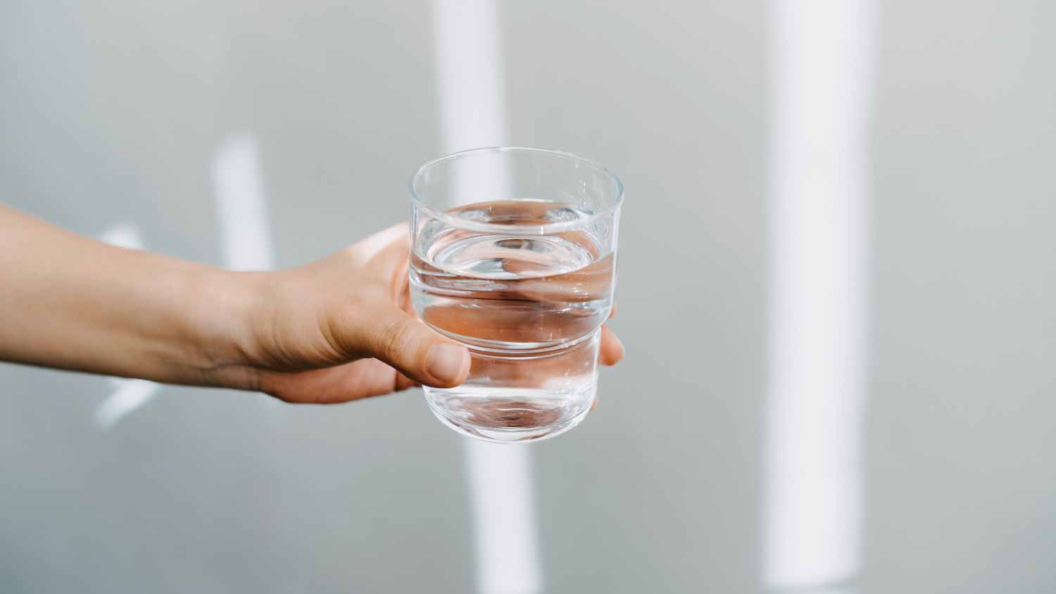 Woman holding a glass of water