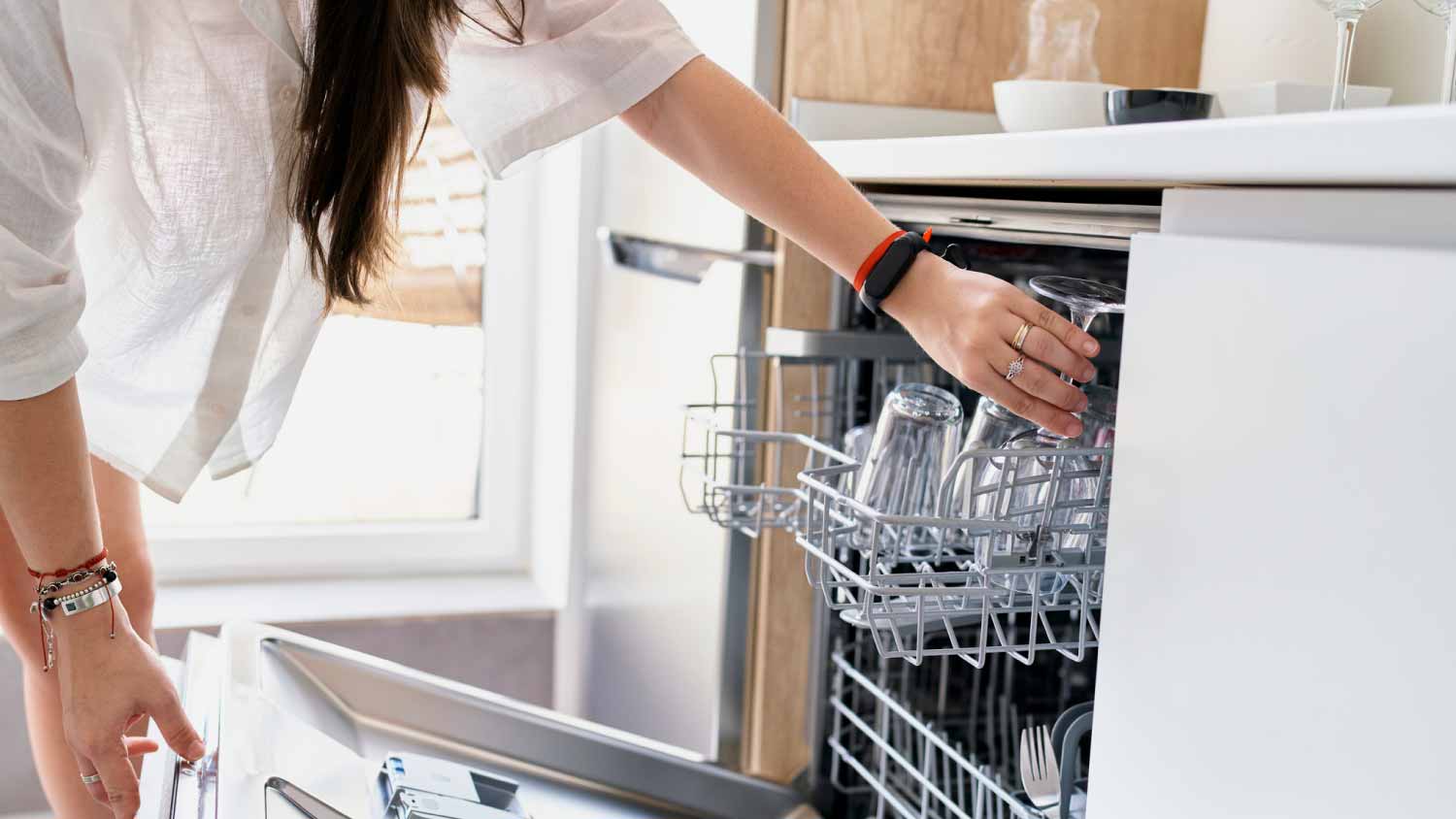 Woman opening a dishwasher