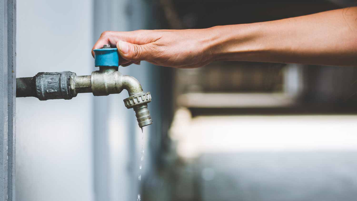 Woman opening faucet