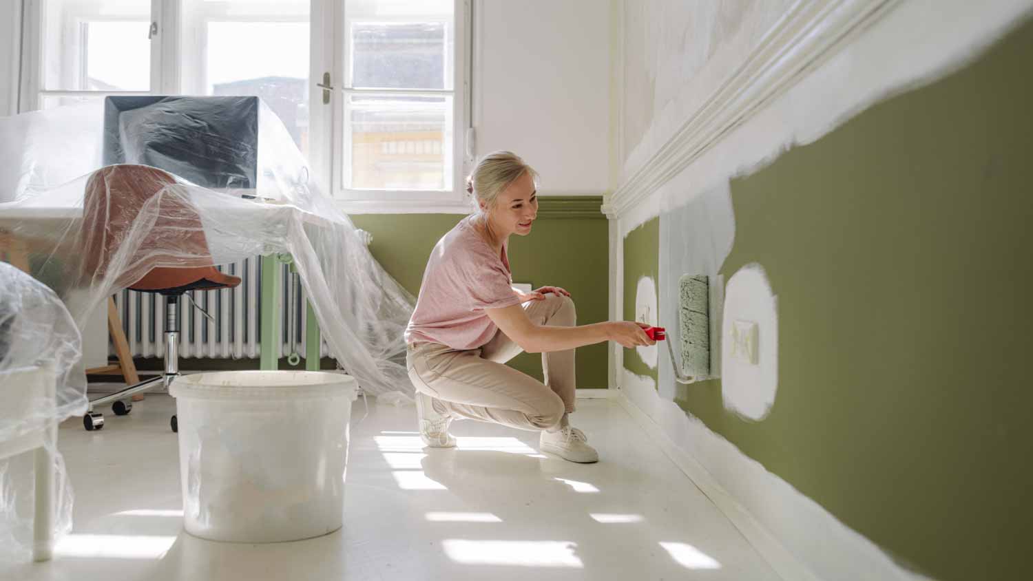 Woman painting a wall