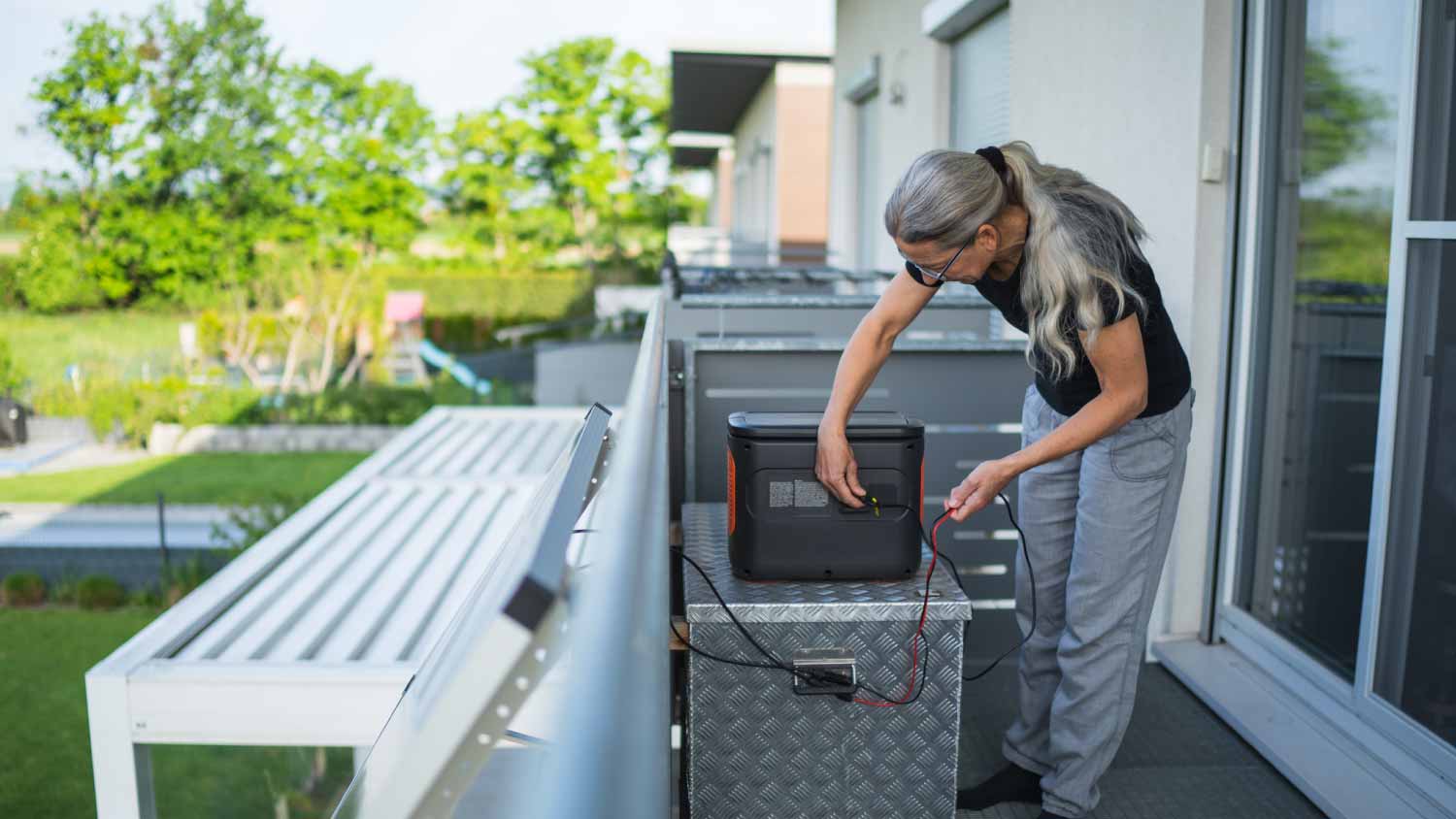 Woman plugging in cable from solar panel