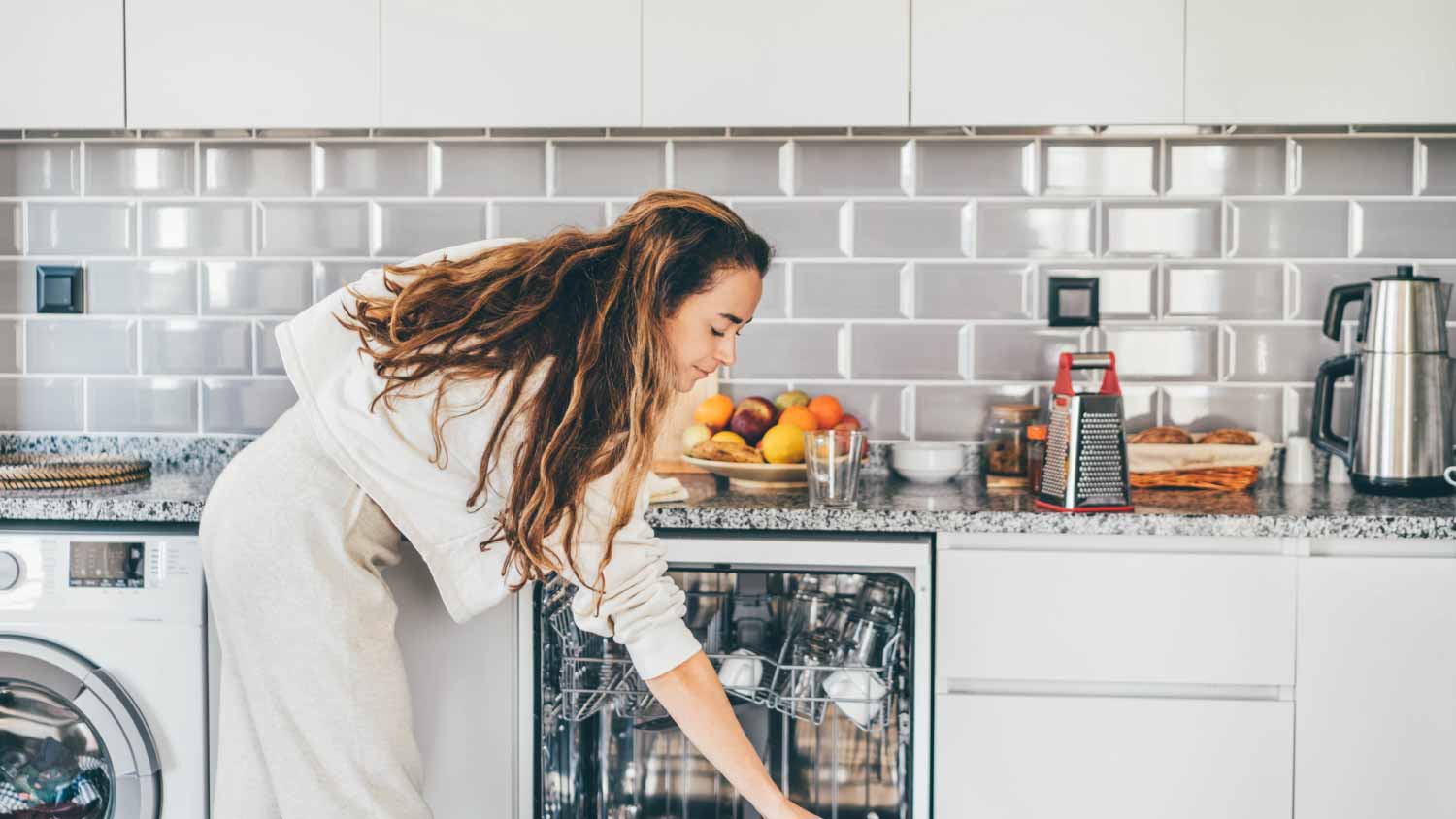 A woman loading the dishwasher