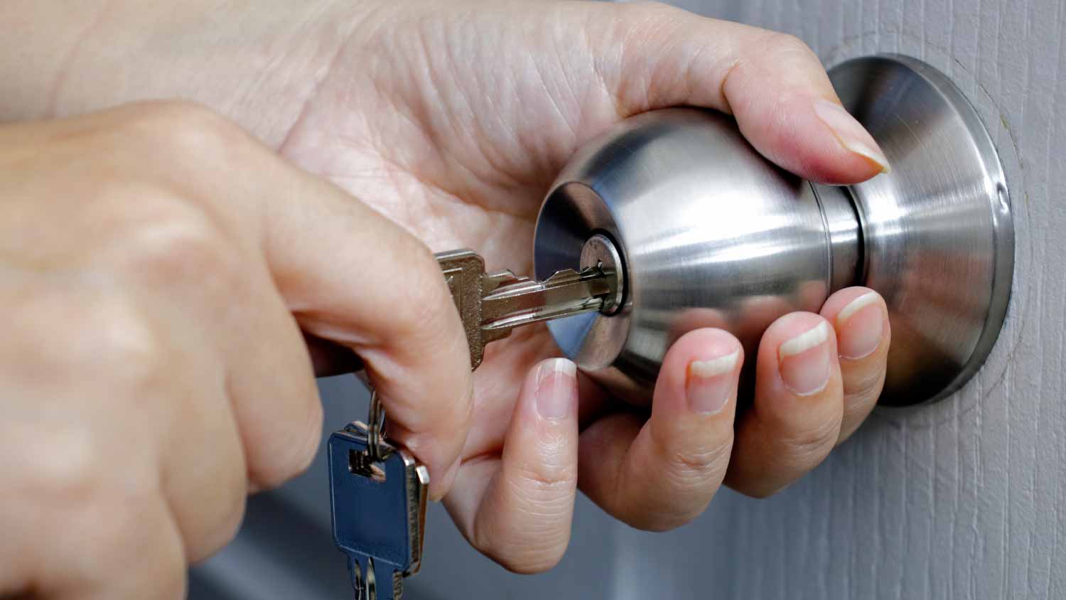 Woman unlocking entrance door