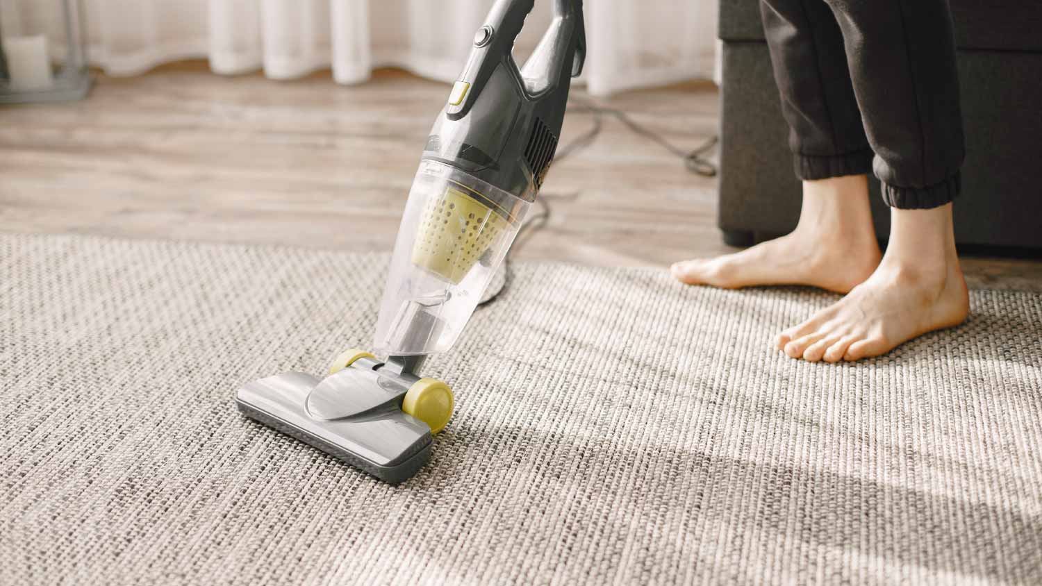 Woman vacuuming mat