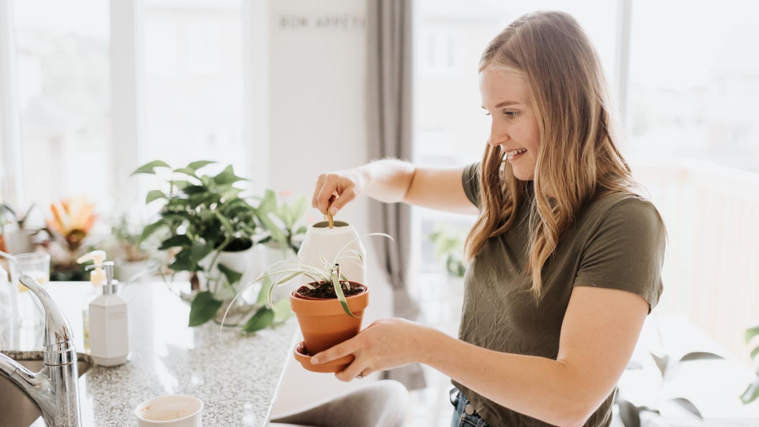 A woman watering house plants