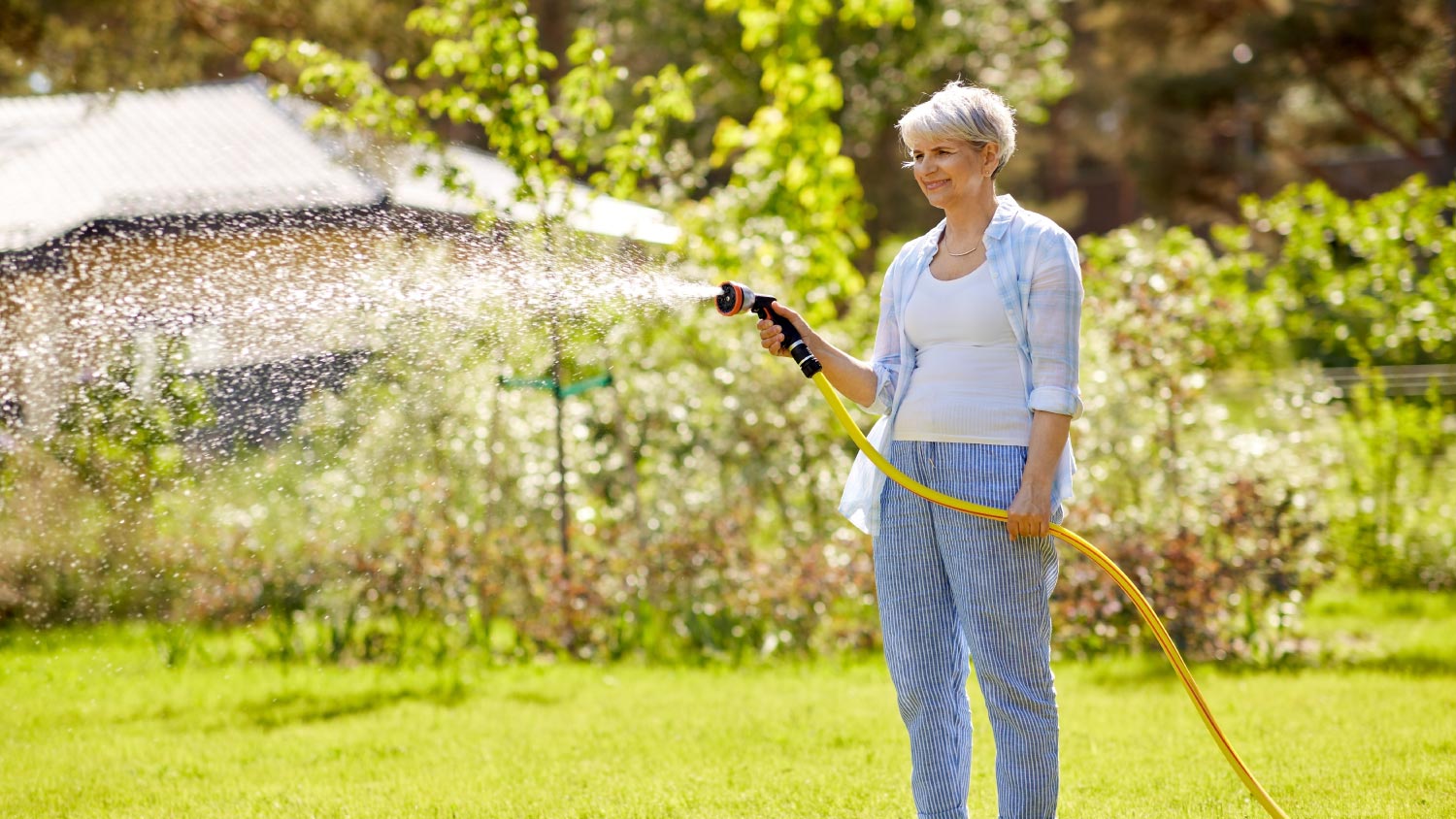 Woman watering the lawn