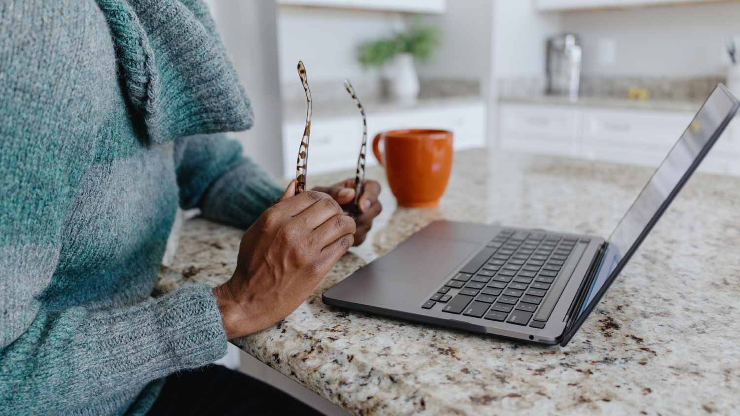 Woman working on laptop in the kitchen