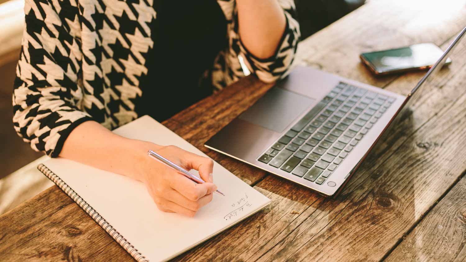 Woman writing a to do list