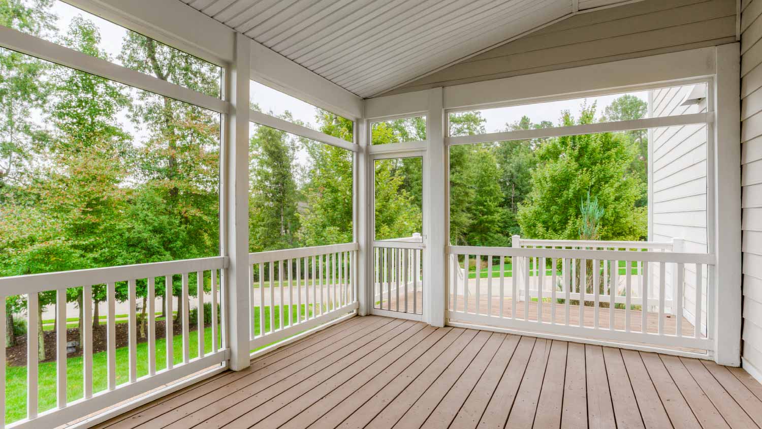 Wooden porch with white railings
