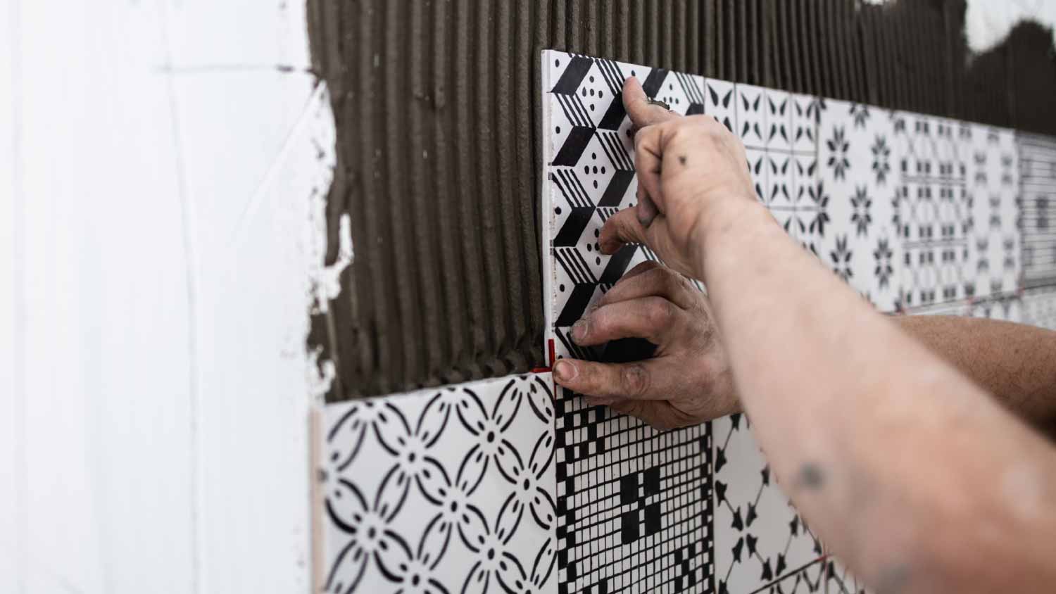 Worker applying ceramic tiles