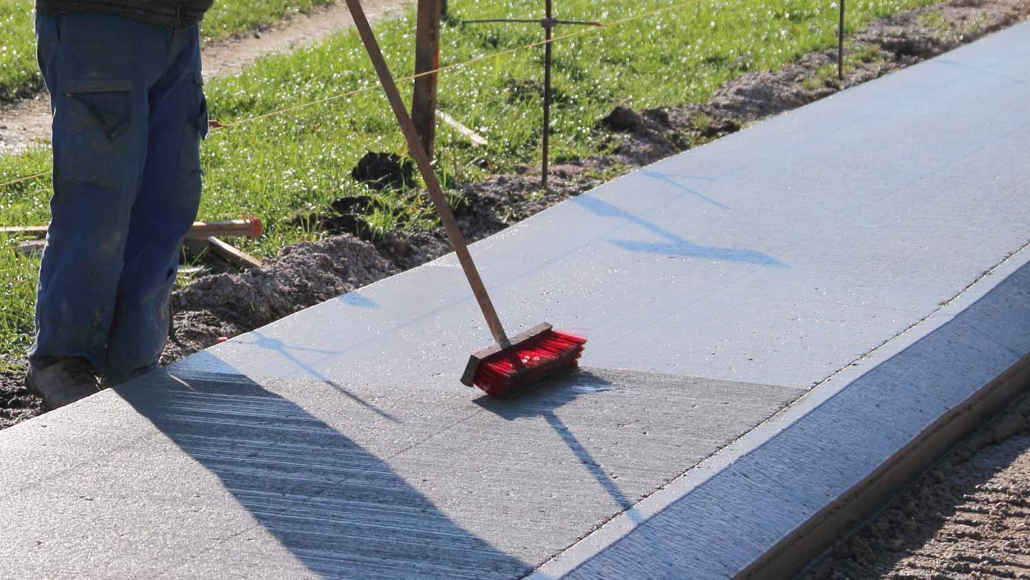 Worker brushing concrete
