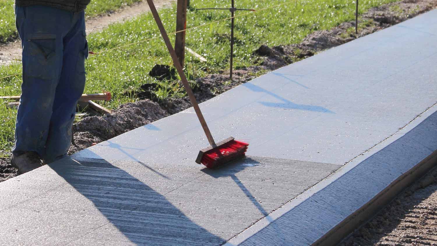 Worker brushing concrete 