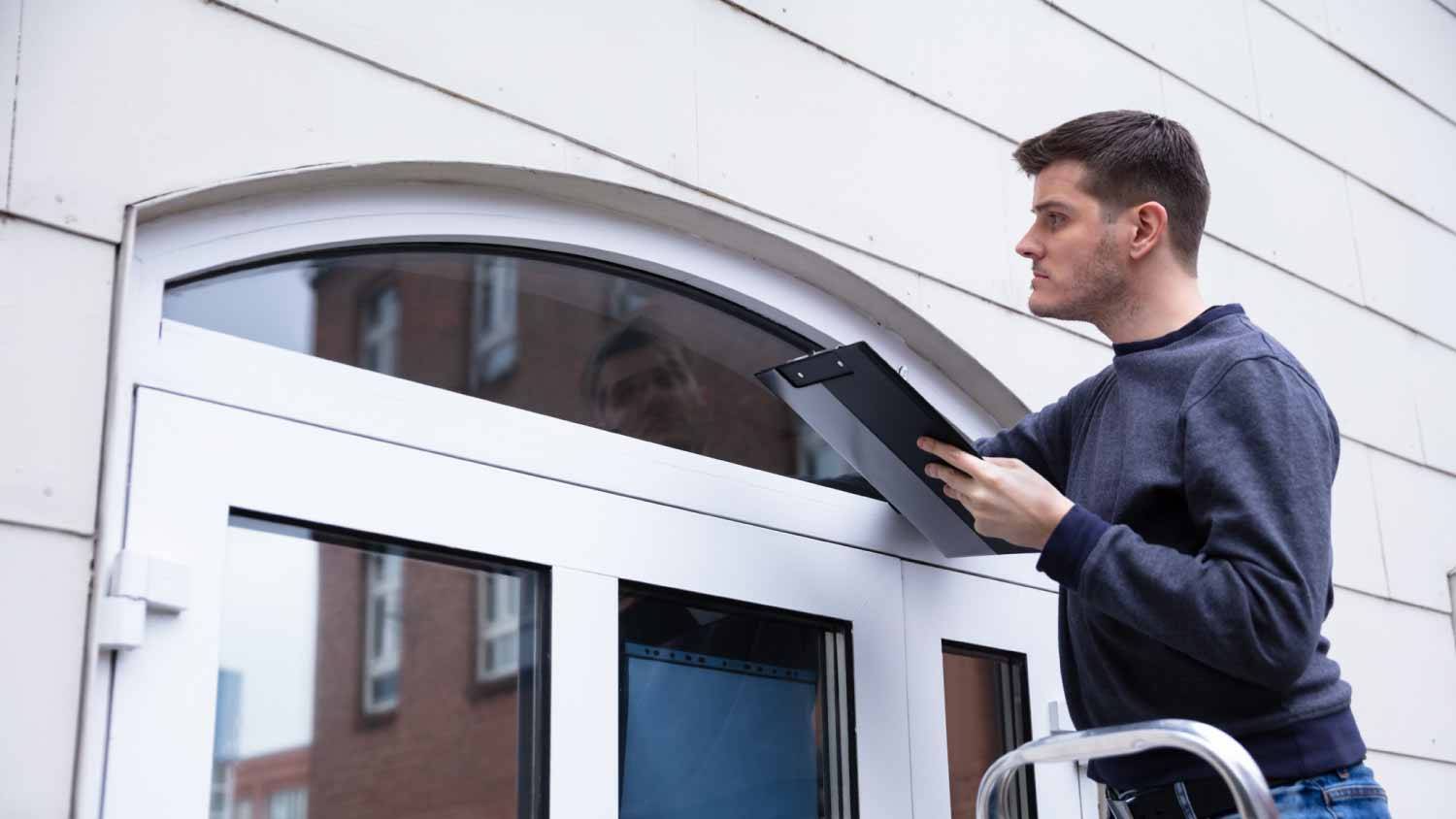 Worker examining door