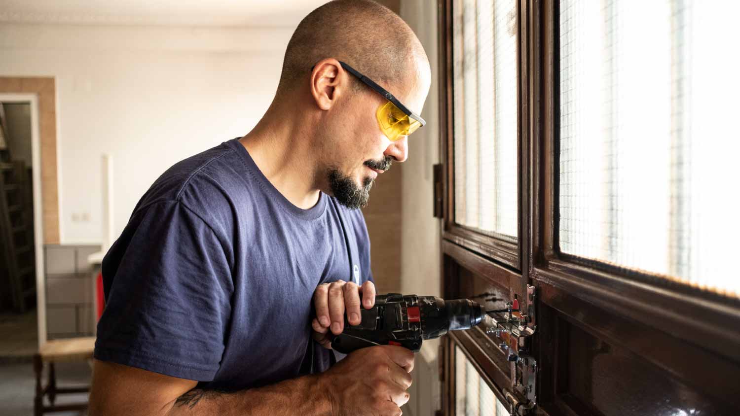 Worker installing door lock