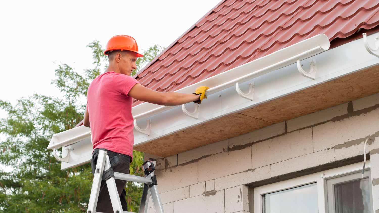 Worker installing gutter