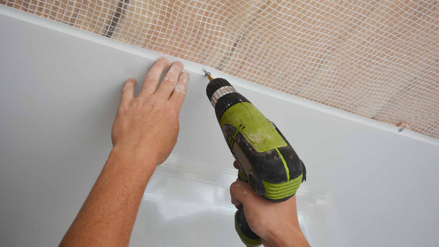 Worker installing plastic panel