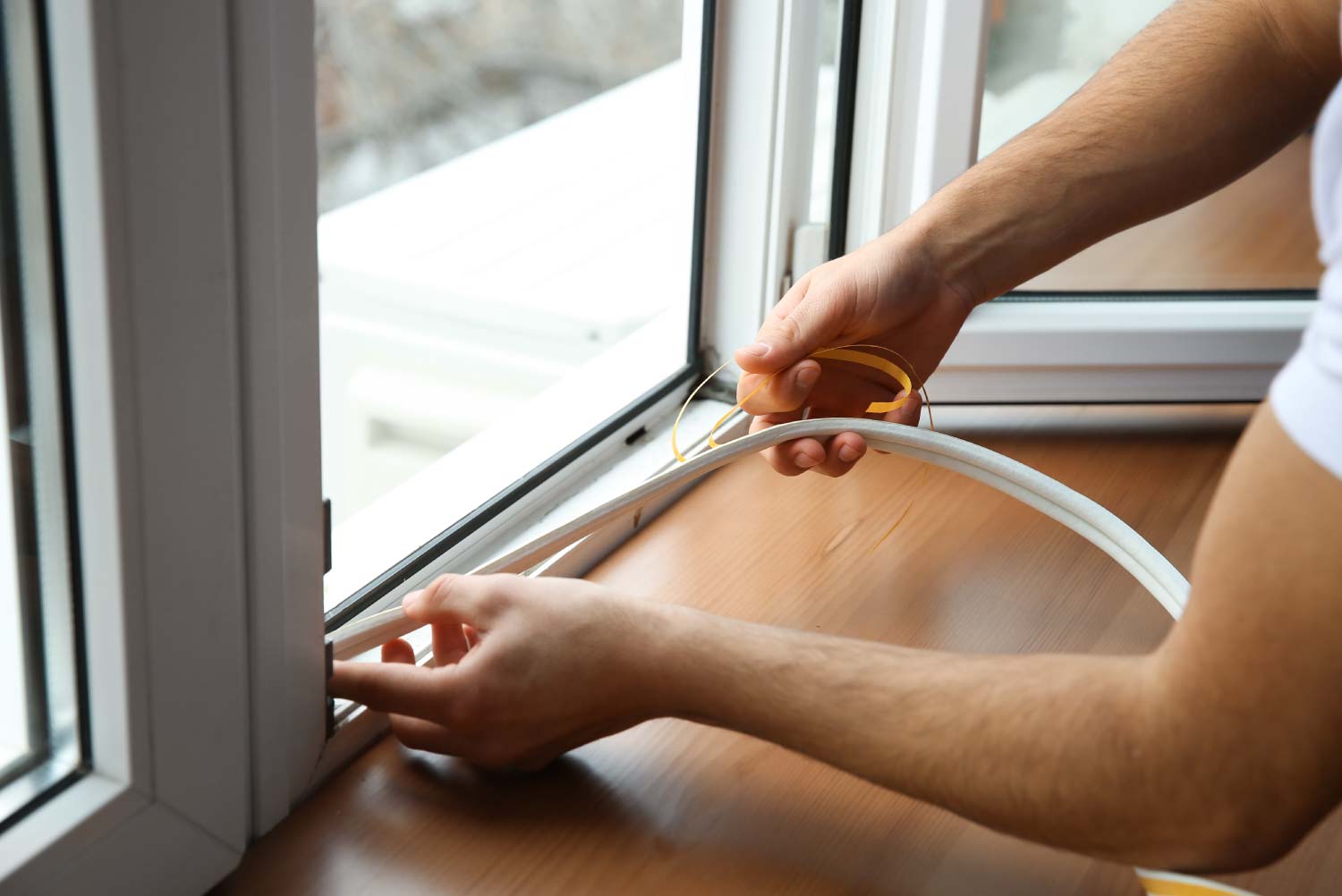 A worker installing a window seal