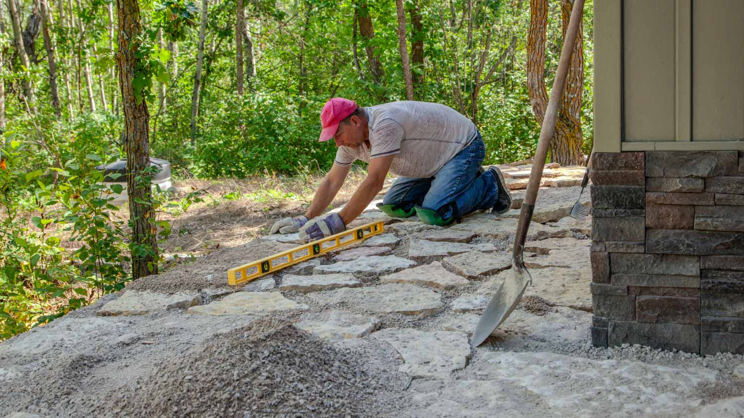 Worker laying flagstone