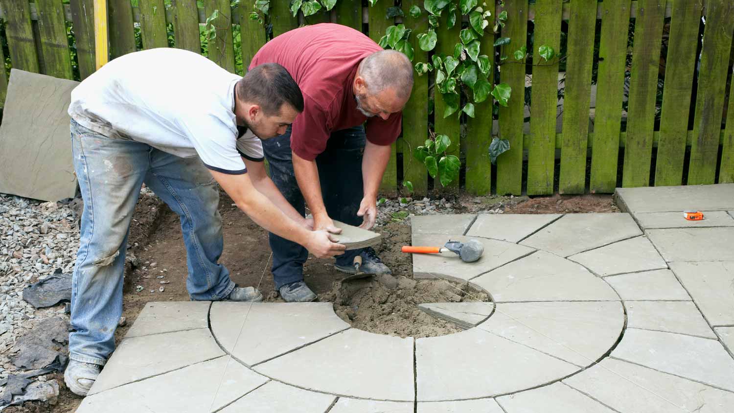 Worker laying paving stones