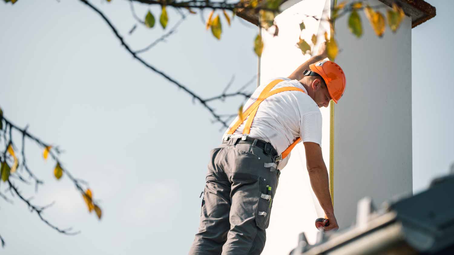 Worker measuring chimney