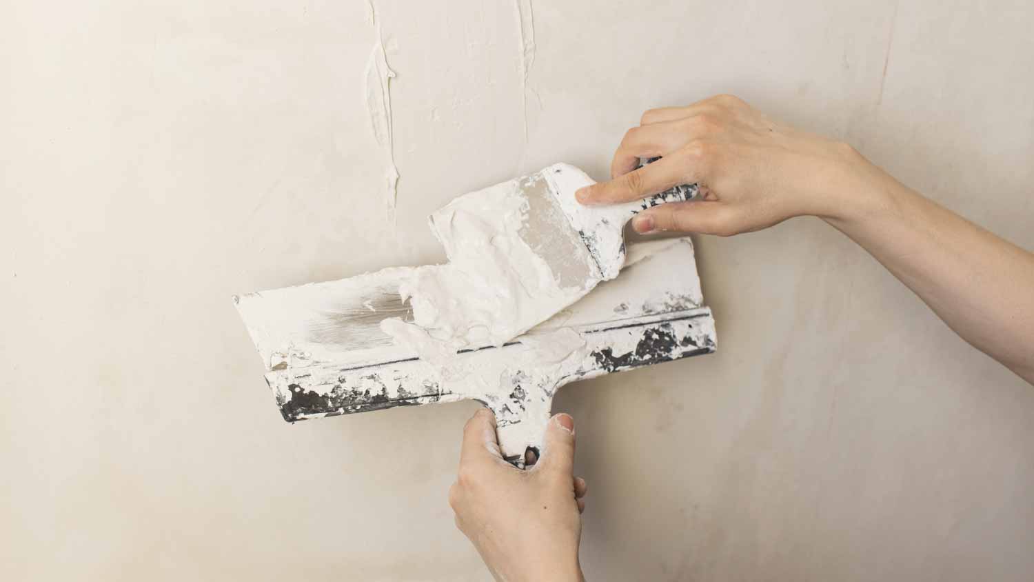 Worker plastering a wall