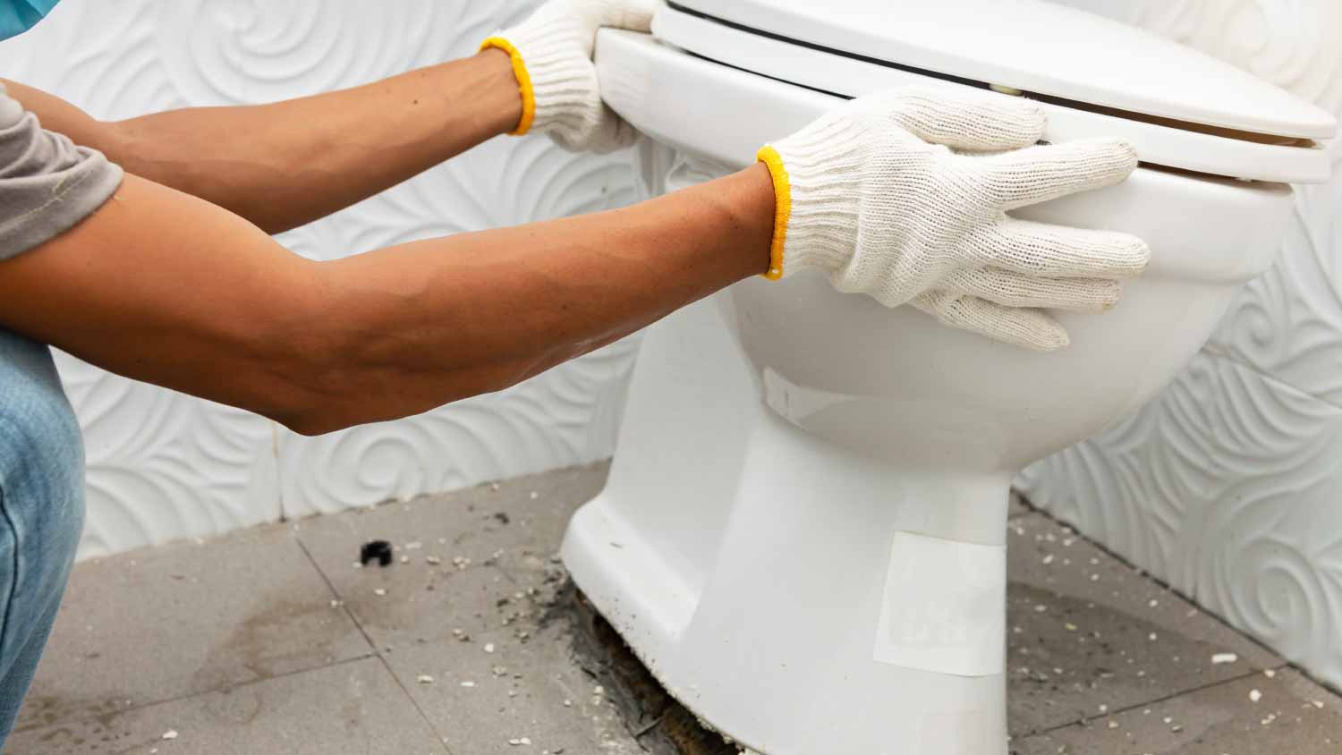 Worker removing toilet