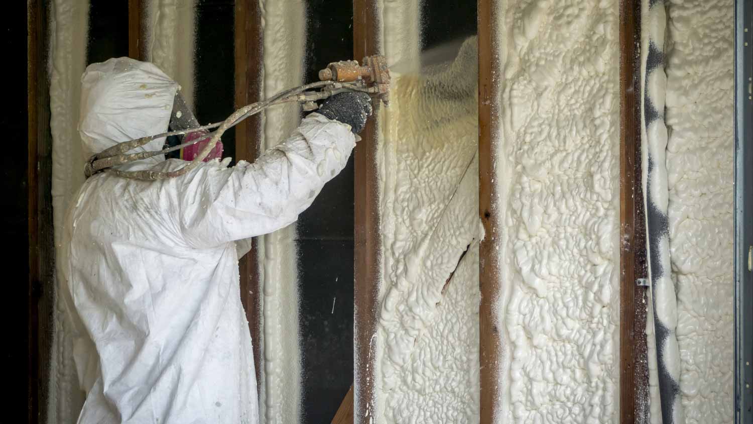 Worker spraying cell spray foam