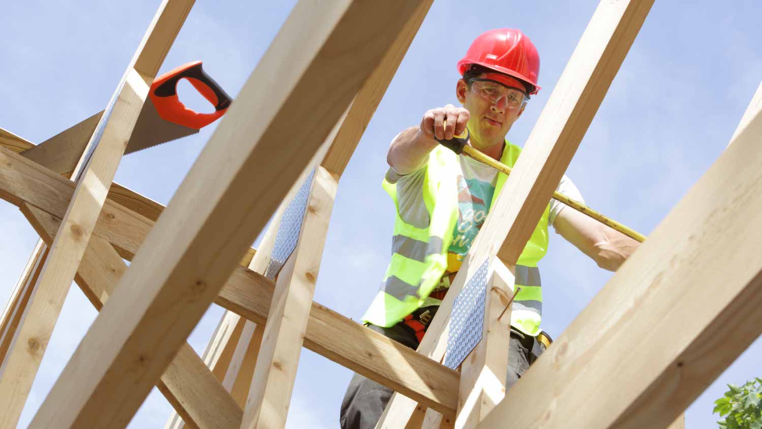 Worker working on roof of house