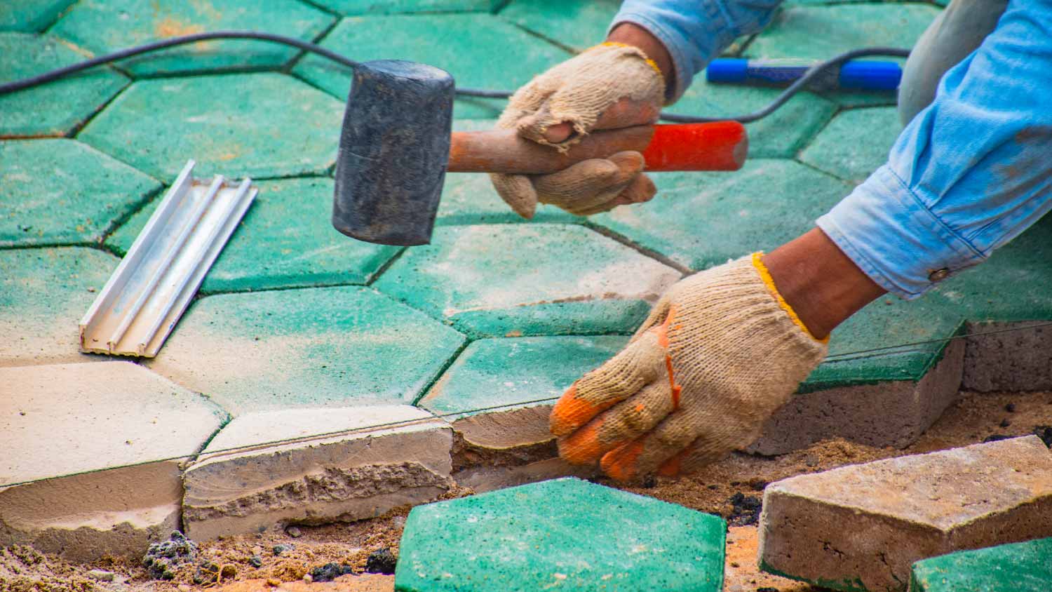 Workers paving brick floors