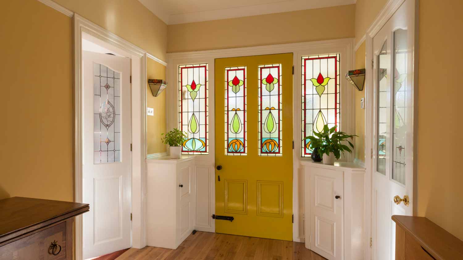 Yellow front door and hallway