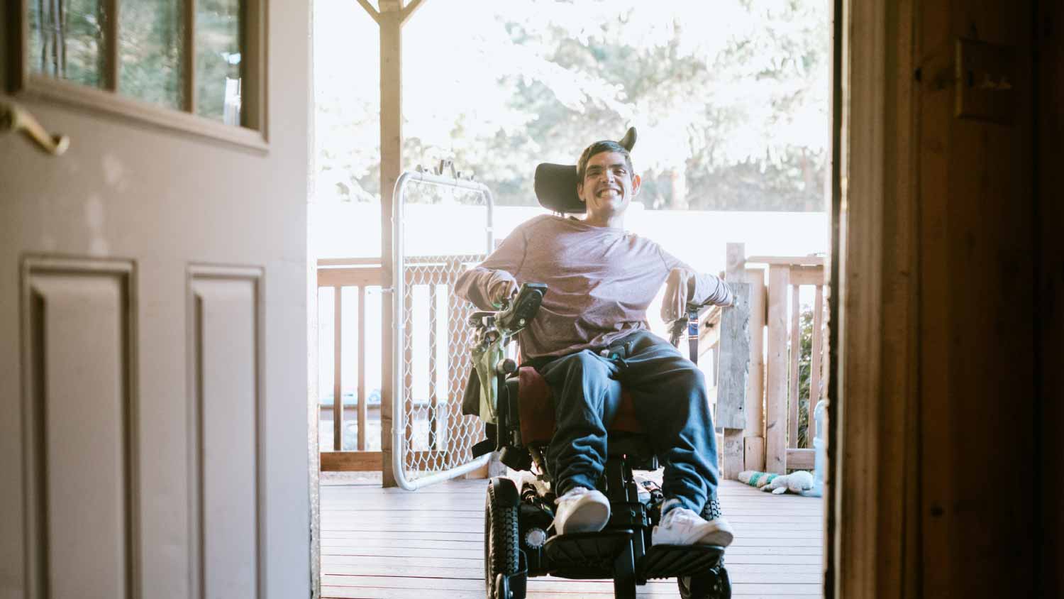 Young man in wheelchair at home