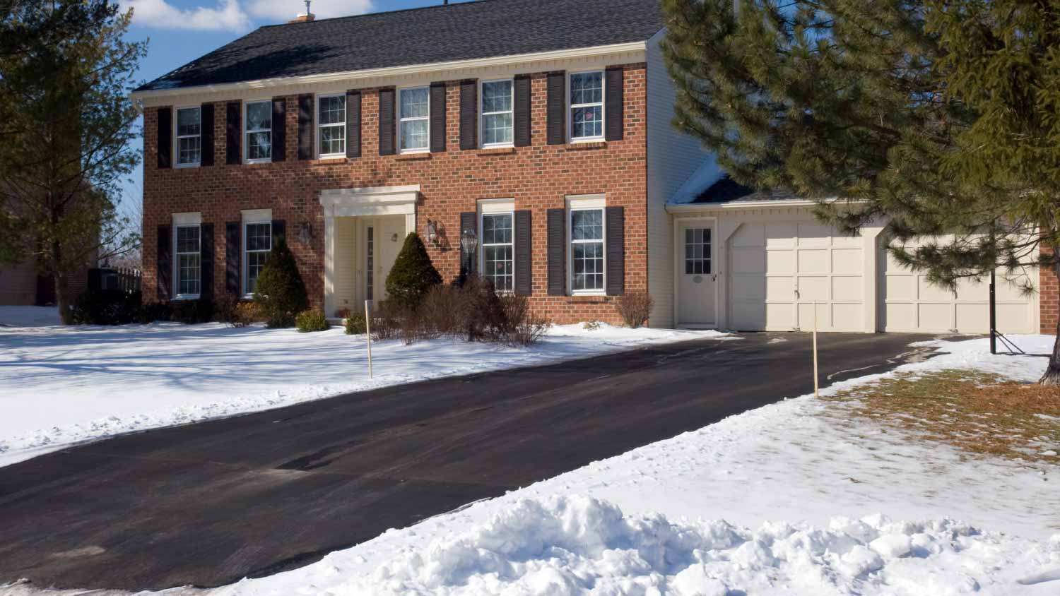 Red Brick Colonial house with snow