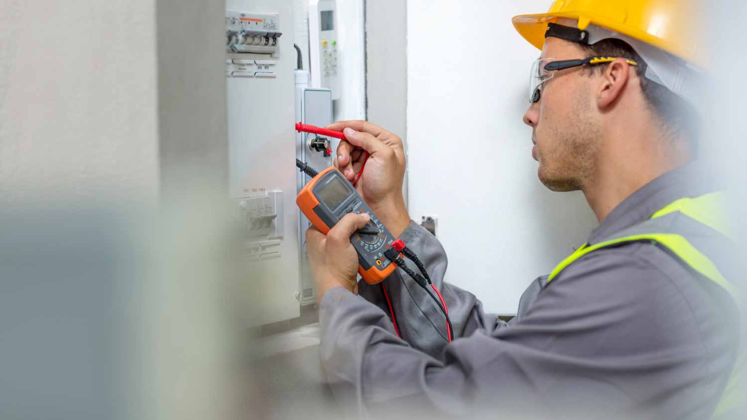 Electrician checking fuse box