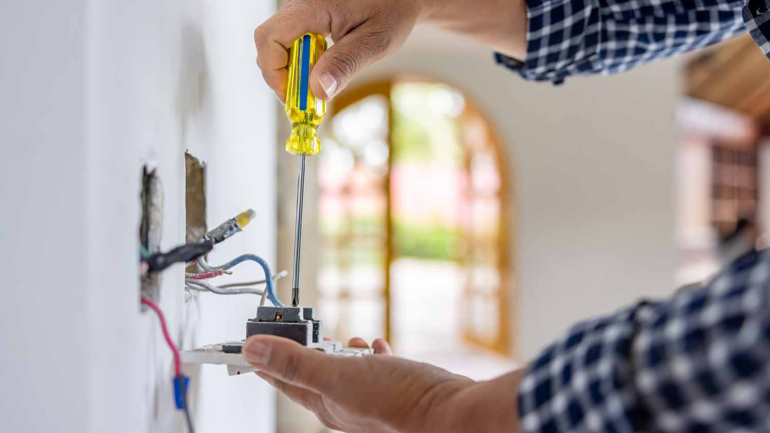 Electrician installing a power outlet