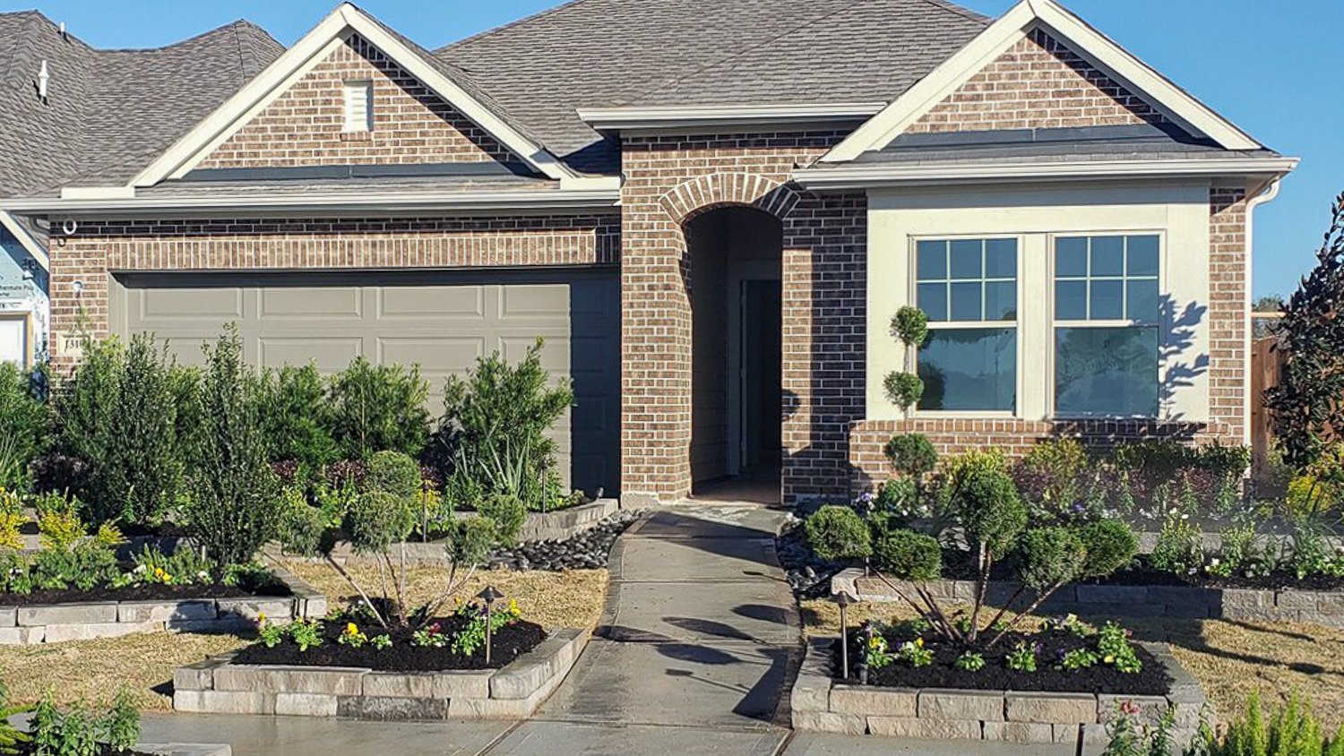 House with a retaining wall and garden