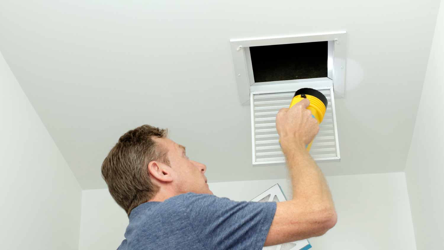 Man checking air ducts system