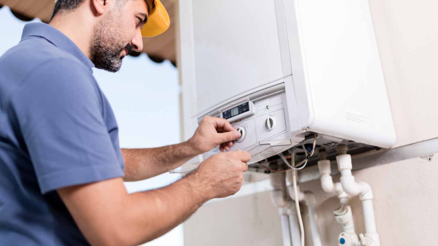 Man checking boiler at home