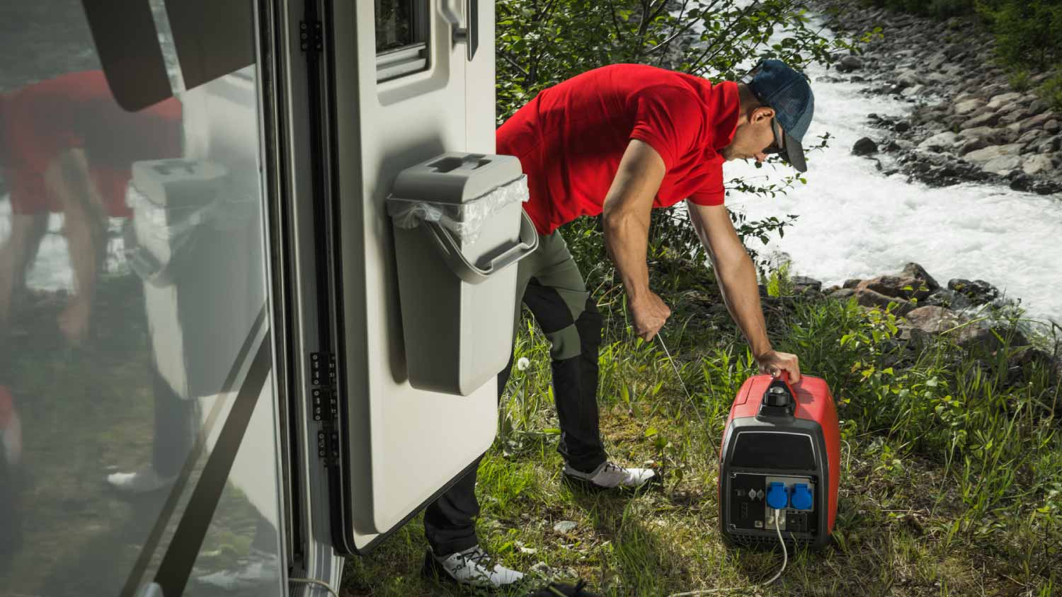 Man firing up gas portable generator